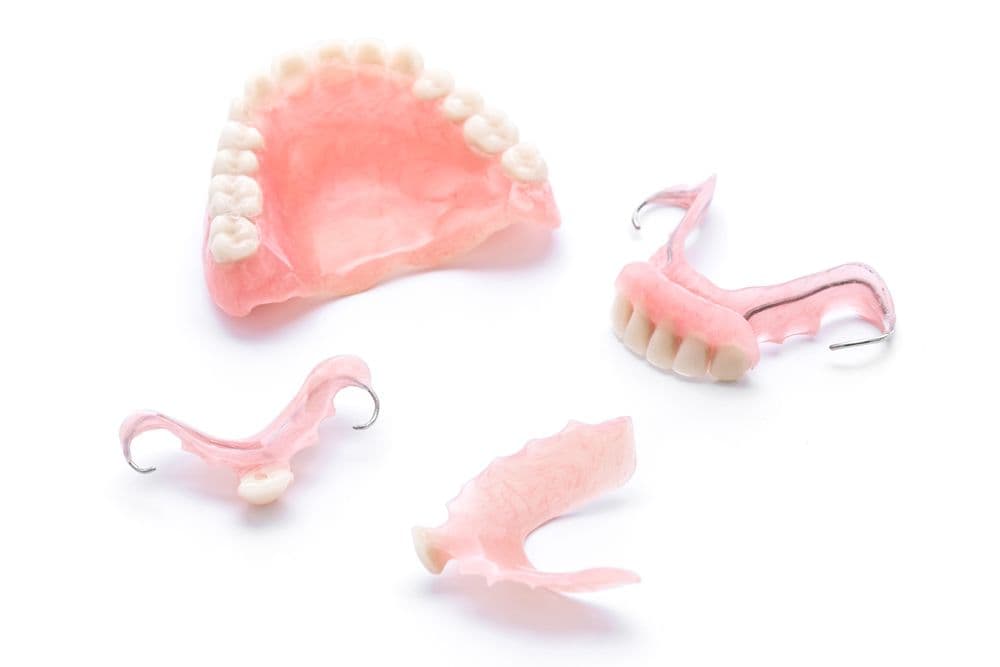 We offer partial dentures as a comfortable and effective solution for those missing one or more teeth but still have some natural teeth remaining. Our partial dentures are custom-made to blend seamlessly with your natural teeth, restoring both function and appearance to your smile.